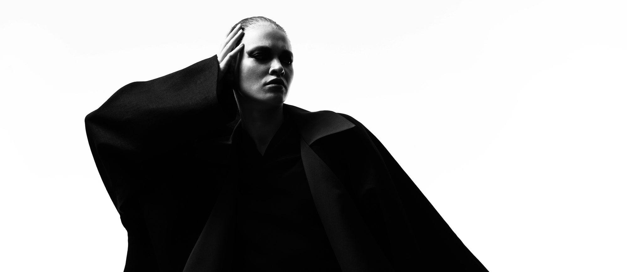 Editorial portrait in an oversized black coat